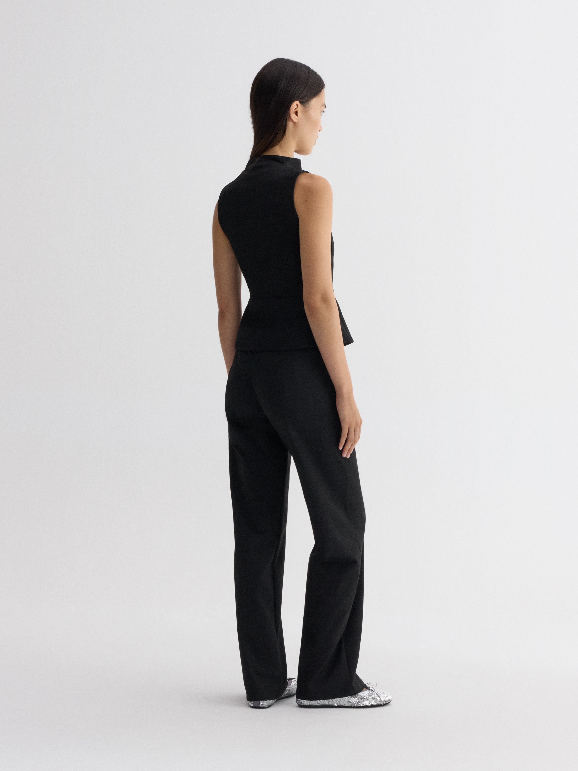 Structured black sleeveless top for women with curved neckline
