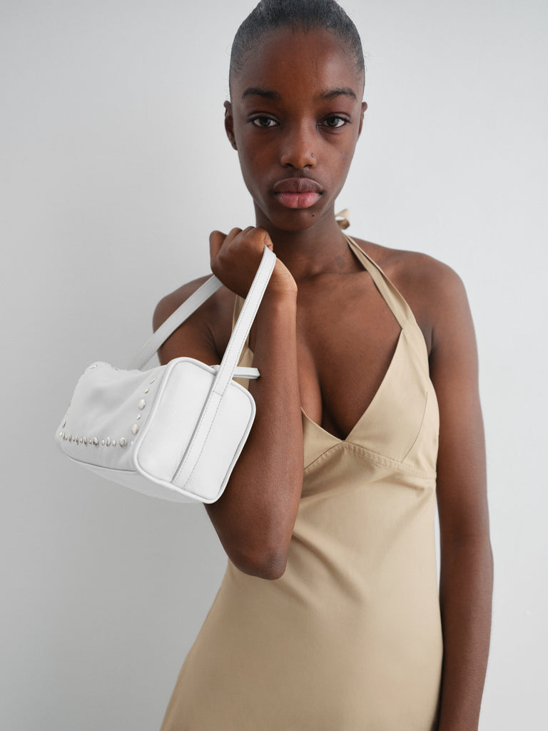 White leather mini baguette bag for women with silver studs