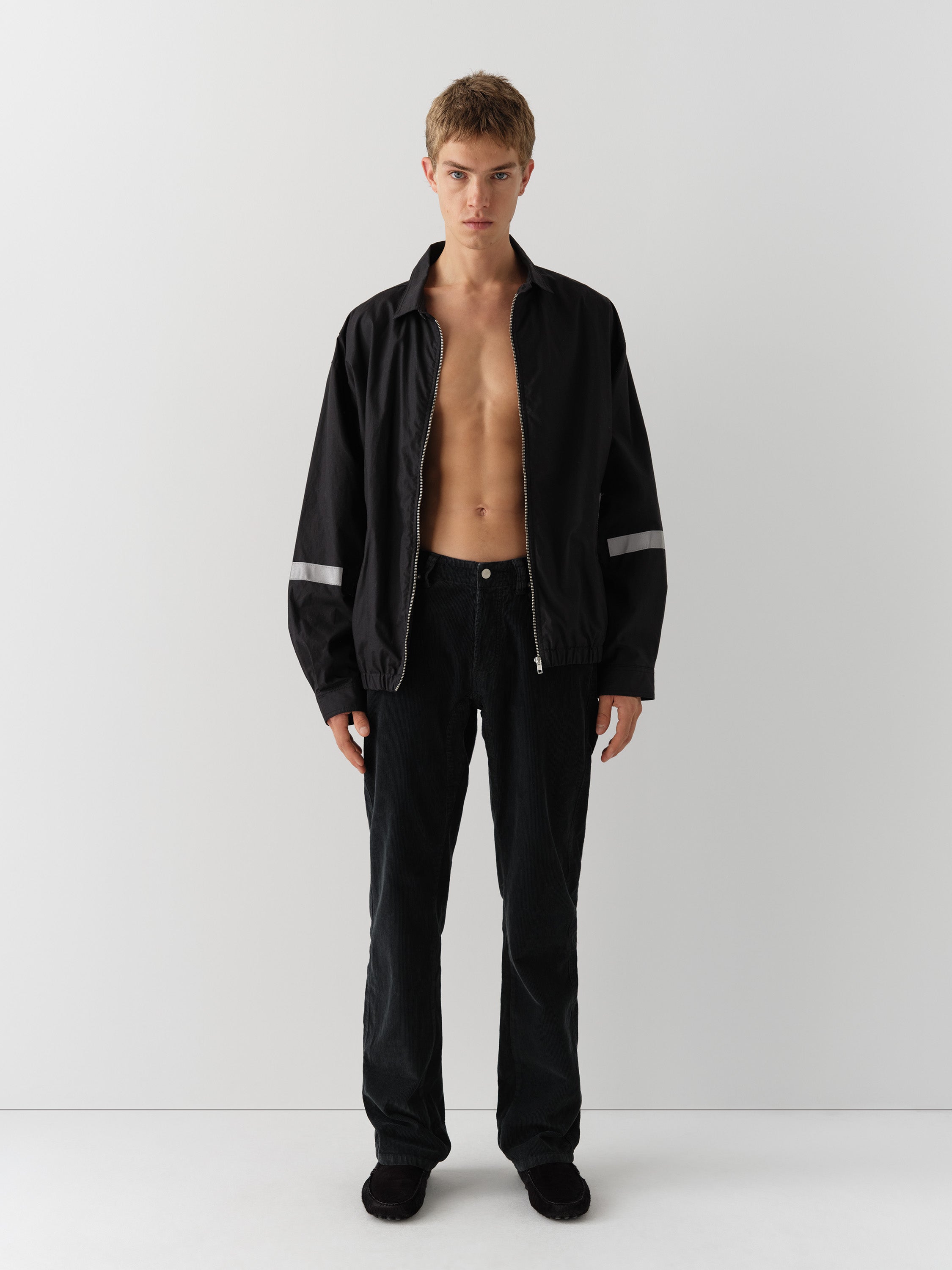 Black unisex waxed-effect jacket with reflective details – Gimaguas